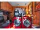 Laundry room with red washer and dryer, and various storage options at 20 Maynard Ave, Orlando, FL 32803