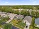 Aerial view of houses in a residential neighborhood with lush green trees and a playground at 213 Hideaway Beach Ln, Kissimmee, FL 34746