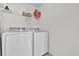 Functional laundry room with washer, dryer, and shelving at 213 Hideaway Beach Ln, Kissimmee, FL 34746