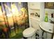 Charming bathroom with frog-themed decor and a shower/tub combo at 222 5Th St, Winter Haven, FL 33880