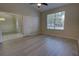 Bedroom with wood-look flooring, ceiling fan, and view of adjacent dining area at 383 Baymoor Way, Lake Mary, FL 32746