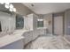 Spa-like Primary bathroom with double vanity, marble flooring, and a large shower at 3867 Grassland Loop, Lake Mary, FL 32746