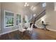 Elegant dining area with glass table and four chairs near staircase at 3867 Grassland Loop, Lake Mary, FL 32746