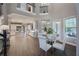 Bright dining area with glass table and four white chairs at 3867 Grassland Loop, Lake Mary, FL 32746