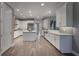 Modern kitchen with white cabinets, stainless steel appliances and hardwood floors at 3867 Grassland Loop, Lake Mary, FL 32746