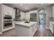 Modern kitchen with white cabinets, island, and stainless steel appliances at 3867 Grassland Loop, Lake Mary, FL 32746