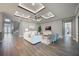 Spacious living room featuring hardwood floors, a coffered ceiling, and ample natural light at 3867 Grassland Loop, Lake Mary, FL 32746