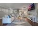 Bright living room with hardwood floors, comfy couch, and large TV at 3867 Grassland Loop, Lake Mary, FL 32746