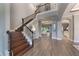 Elegant staircase leading to upper level, showcasing hardwood floors at 3867 Grassland Loop, Lake Mary, FL 32746
