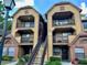 Two-story building with brick and wood siding, featuring a staircase and balconies at 485 Forestway Cir # 202, Altamonte Springs, FL 32701