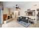Living room featuring a gray sectional sofa, fireplace, and view into kitchen area at 5027 Jamaica Cir # 7, Orlando, FL 32808