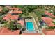 Island Club community pool with surrounding patio and lush landscaping at 5027 Jamaica Cir # 7, Orlando, FL 32808