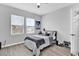 Well-lit bedroom with a striped bedspread and ceiling fan at 5596 Mangrove Cove Ave, Winter Garden, FL 34787