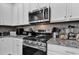 Modern kitchen features stainless steel appliances and granite countertops at 5596 Mangrove Cove Ave, Winter Garden, FL 34787