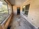 Enclosed porch with concrete flooring and windows at 6301 State Road 60 E, Bartow, FL 33830