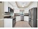 Modern kitchen with stainless steel appliances and white cabinetry at 6641 Doubletrace Ln, Orlando, FL 32819