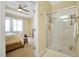 Clean bathroom with walk-in shower and view into bedroom at 8327 Riverdale Ln, Davenport, FL 33896