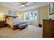 Large bedroom with king-size bed, ample natural light, and plush carpeting at 8327 Riverdale Ln, Davenport, FL 33896