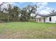 White house with covered patio and large backyard at 8827 Sw 137Th Ct, Ocala, FL 34481