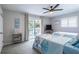 Guest bedroom with two twin beds, ocean-themed bedding, and private balcony at 906 Maple St, New Smyrna Beach, FL 32169