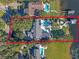 Stunning aerial view of a luxurious waterfront estate with a pool, lush landscaping, and private dock at 100 Blue Lake Ct, Longwood, FL 32779