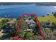 Spectacular aerial view showcasing the expansive property, waterfront location, and surrounding mature trees at 100 Blue Lake Ct, Longwood, FL 32779