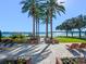 Relaxing backyard oasis with palm trees, lounge chairs, and waterfront views at 100 Blue Lake Ct, Longwood, FL 32779