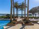 Tropical backyard oasis with pool, spa, and lush landscaping, overlooking the lake at 100 Blue Lake Ct, Longwood, FL 32779