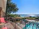Relaxing balcony with scenic lake views, pool, and lush landscaping at 100 Blue Lake Ct, Longwood, FL 32779