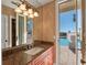 Elegant bathroom with granite countertop vanity and access to the pool area at 100 Blue Lake Ct, Longwood, FL 32779
