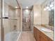 Elegant bathroom featuring decorative wallpaper, granite countertops, and glass shower at 100 Blue Lake Ct, Longwood, FL 32779