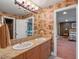 Bathroom with double vanity, granite countertop, and decorative wallpaper at 100 Blue Lake Ct, Longwood, FL 32779