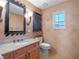 Bathroom with decorative tiled walls, wood vanity, and a window at 100 Blue Lake Ct, Longwood, FL 32779