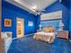 Bright blue bedroom with plush carpeting, large window, and ensuite bathroom at 100 Blue Lake Ct, Longwood, FL 32779