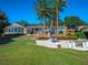 Lakefront home with putting green, patio, and lush landscaping at 100 Blue Lake Ct, Longwood, FL 32779