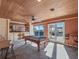 Spacious game room featuring pool table, built-in bar, and tranquil water views at 100 Blue Lake Ct, Longwood, FL 32779