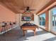 Inviting game room with pool table, bar, and abundant natural light at 100 Blue Lake Ct, Longwood, FL 32779
