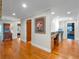 Hallway with hardwood floors, built-in desk, and doorway to another room at 100 Blue Lake Ct, Longwood, FL 32779