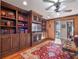 Built-in bookcases, fireplace, and water view in cozy library at 100 Blue Lake Ct, Longwood, FL 32779