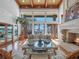 Living room with fireplace, large windows, and view of the pool and water at 100 Blue Lake Ct, Longwood, FL 32779