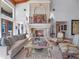 Elegant living room with a fireplace, large windows, and a view of the backyard at 100 Blue Lake Ct, Longwood, FL 32779