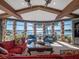 Living room with plush seating, natural light, and picturesque water views at 100 Blue Lake Ct, Longwood, FL 32779