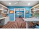 Home office with blue walls, built-in bookshelves, and a view of the gym at 100 Blue Lake Ct, Longwood, FL 32779