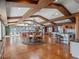 Open plan living, dining, and kitchen with wood beams and lake views at 100 Blue Lake Ct, Longwood, FL 32779