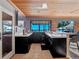 Outdoor kitchen with black cabinets, white countertops, and a water view at 100 Blue Lake Ct, Longwood, FL 32779