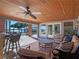 Covered patio area with seating, outdoor kitchen, and pool views at 100 Blue Lake Ct, Longwood, FL 32779