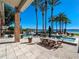 Spacious patio with outdoor dining, overlooking the pool, spa, and lake at 100 Blue Lake Ct, Longwood, FL 32779