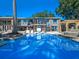 Sparkling pool reflecting the home's modern architecture and the clear blue sky at 100 Blue Lake Ct, Longwood, FL 32779