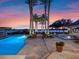 Luxury backyard oasis with pool, spa, and waterfront views at sunset at 100 Blue Lake Ct, Longwood, FL 32779