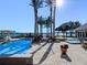 Resort-style pool area with palm trees, a spa, and stunning lake views at 100 Blue Lake Ct, Longwood, FL 32779
